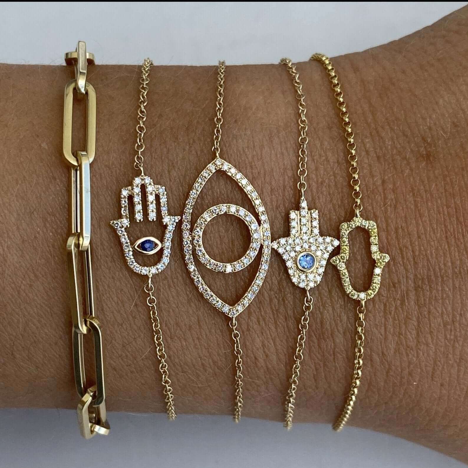 Gold chain bracelet set featuring handmade hamsa and evil eye charms – luxury jewelry for protection and style.