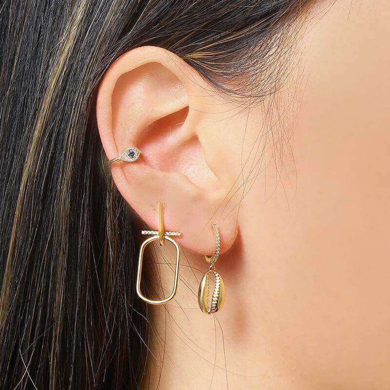 Woman wearing stylish gold earrings from our jewelry brand collection
