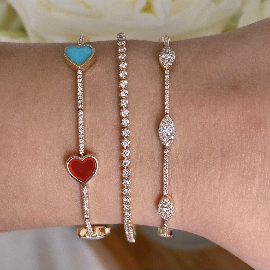 Stylish gold bracelets with heart charms and diamond accents from our luxury jewelry collection