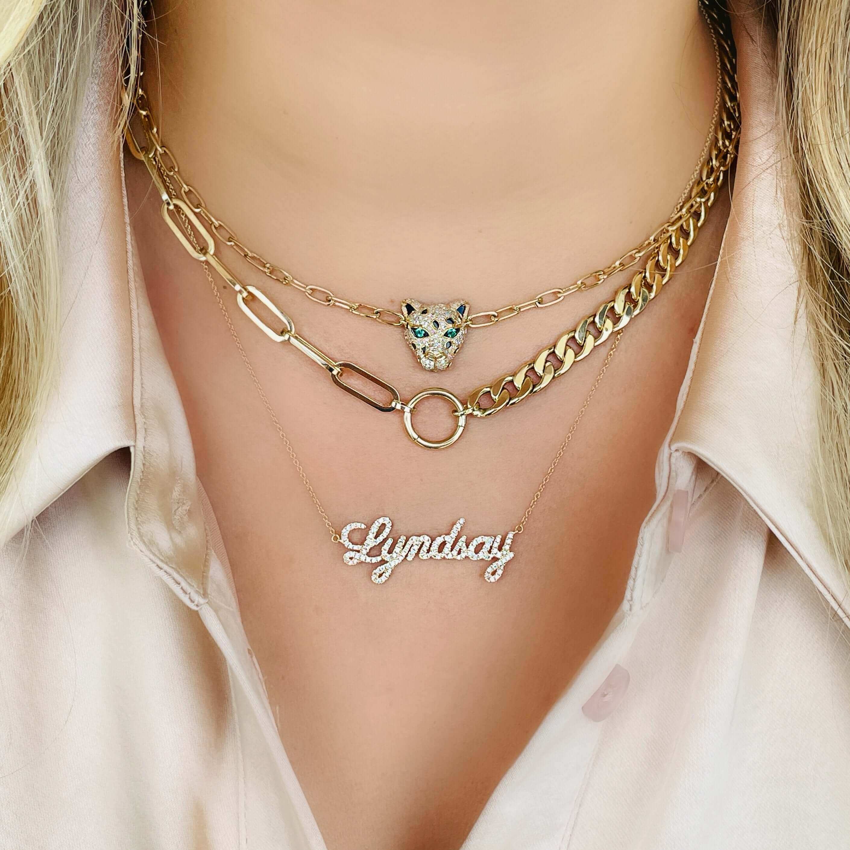 Layered gold chain necklaces with a leopard charm and a personalized name pendant by our jewelry brand.