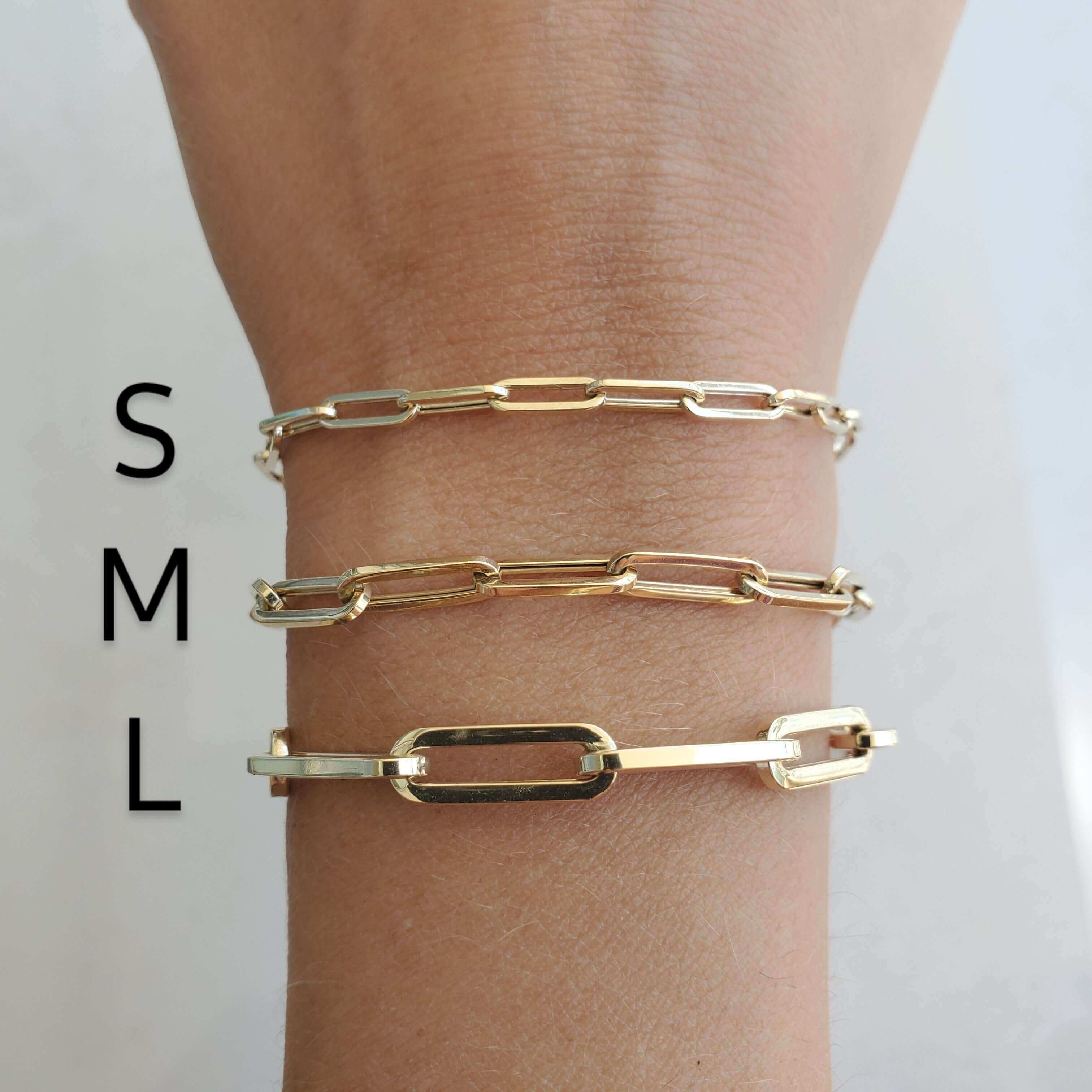 Gold chain link bracelets in small, medium, and large sizes on wrist, showcasing elegant jewelry options from our brand.