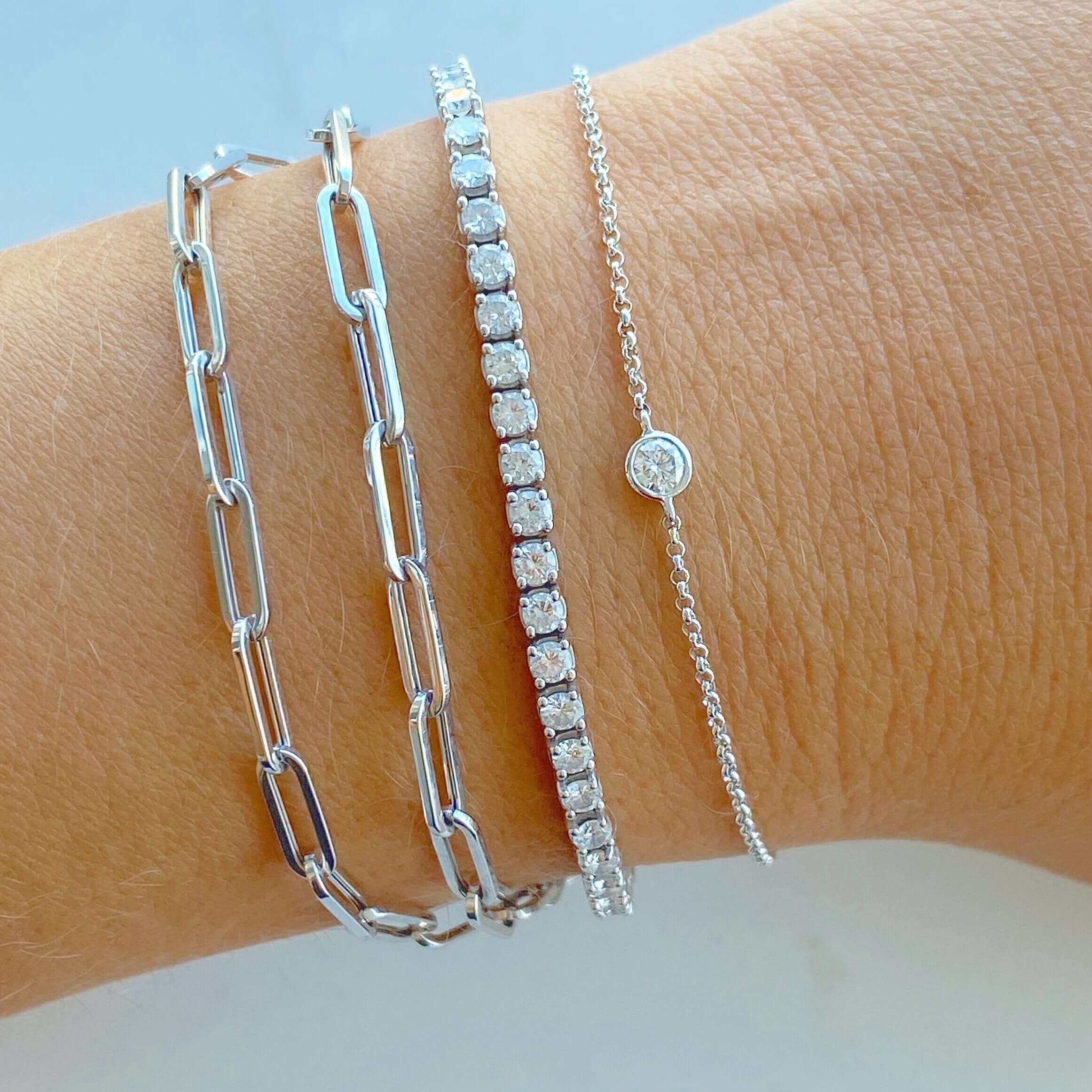 Elegant silver chain and diamond bracelet set on wrist showcases luxury jewelry brand craftsmanship.