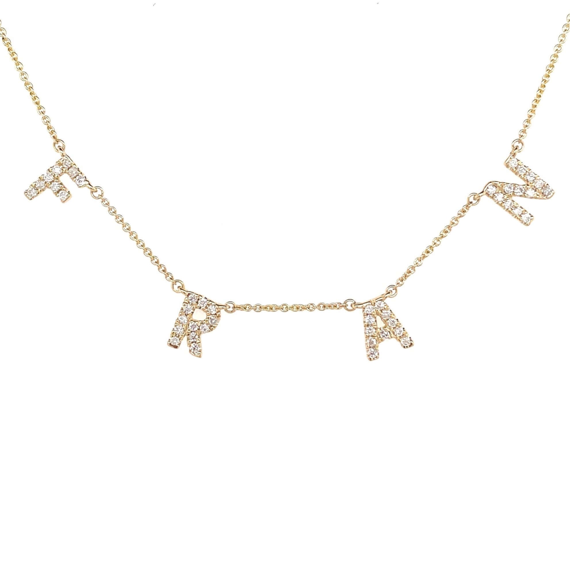 Gold initial necklace with sparkling diamond letters by our jewelry brand.