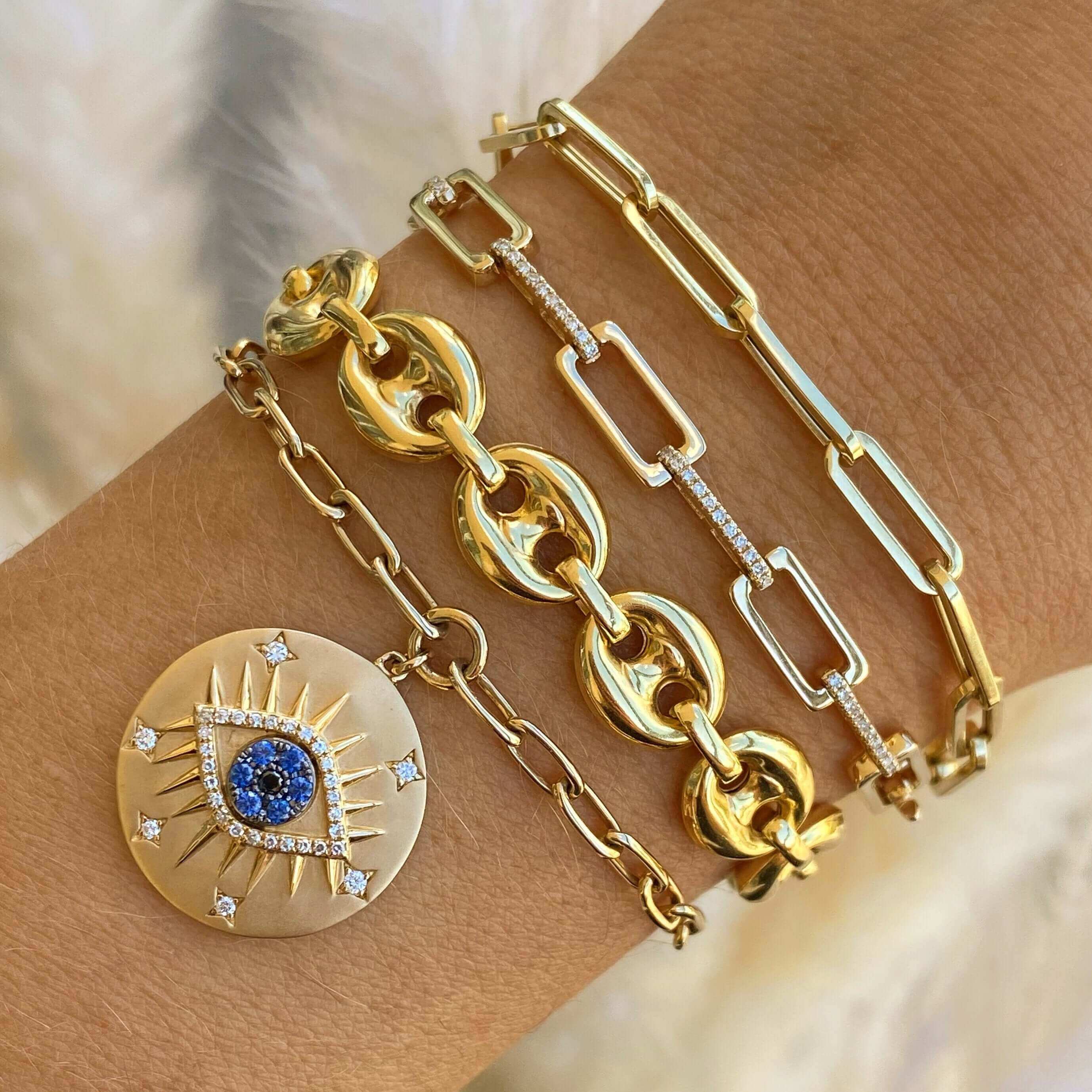 Stunning gold bracelets with a blue diamond pendant from our luxury jewelry brand collection.