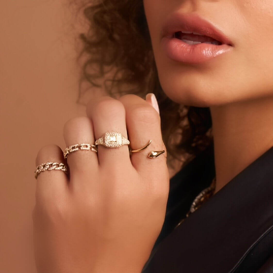 Woman wearing luxurious gold rings from our exclusive jewelry collection.
