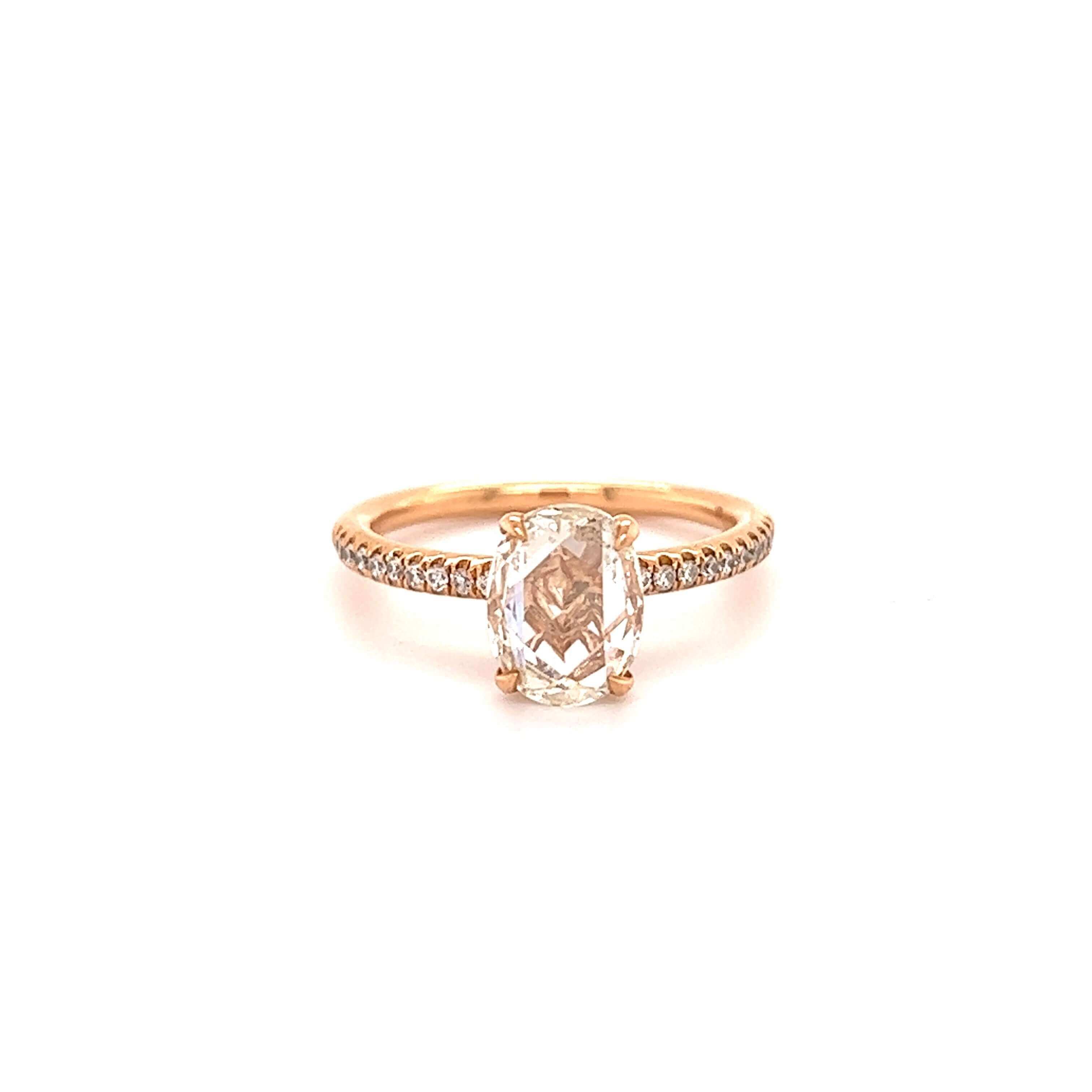 Elegant gold engagement ring with cushion-cut diamond and diamond-studded band from our exclusive jewelry collection.