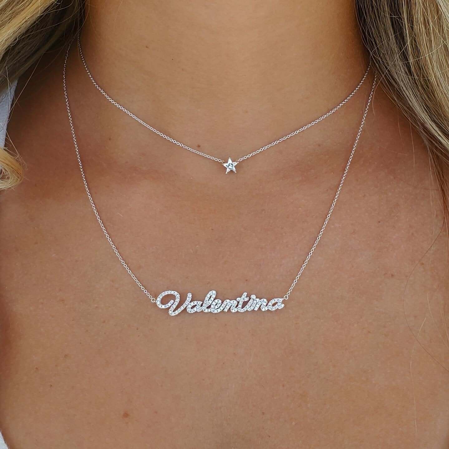 Layered silver necklaces with personalized name "Valentina" and a star charm, highlighting delicate jewelry from our exclusive collection.