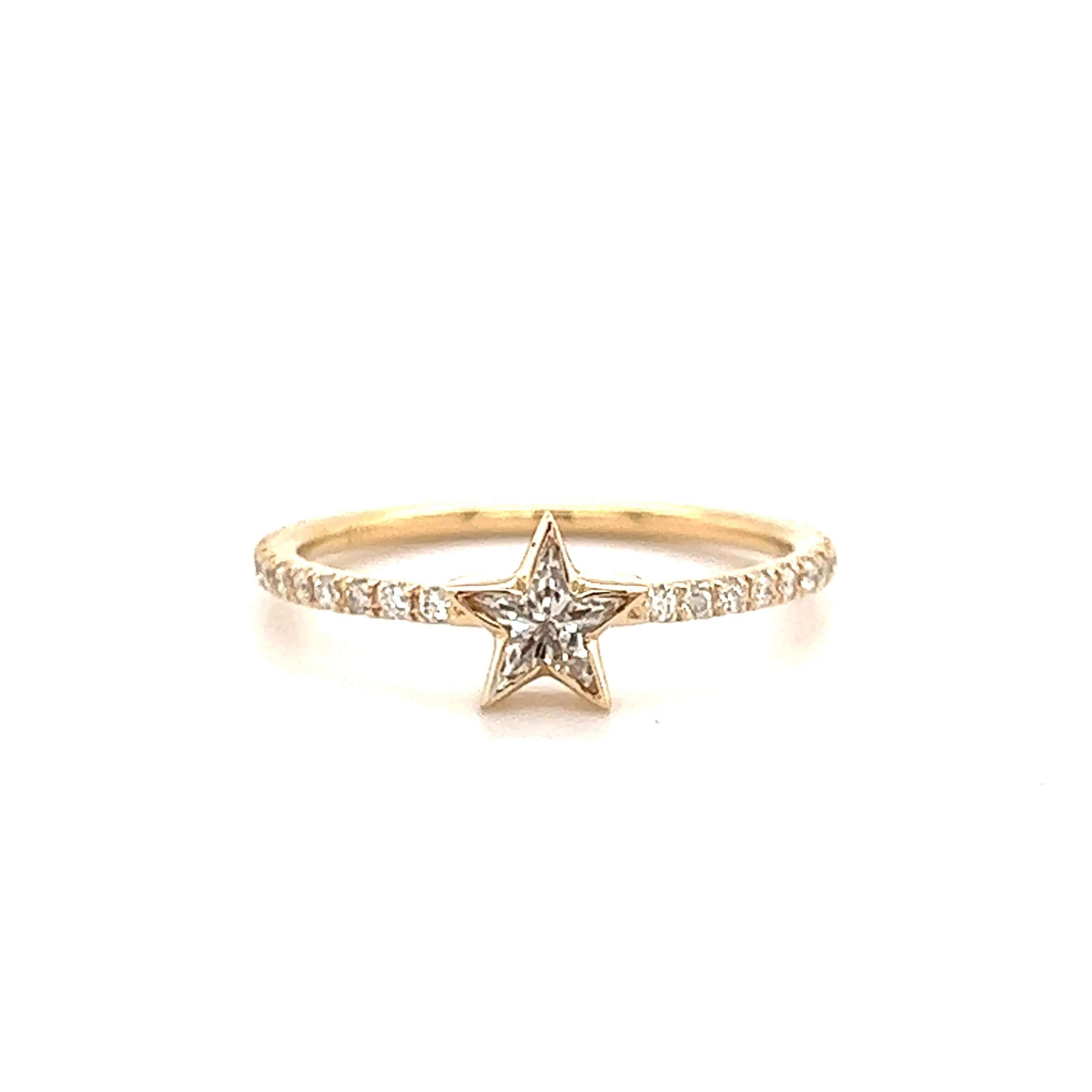 Delicate gold ring with a sparkling star centerpiece and diamond accents, perfect for adding a touch of elegance to any outfit.