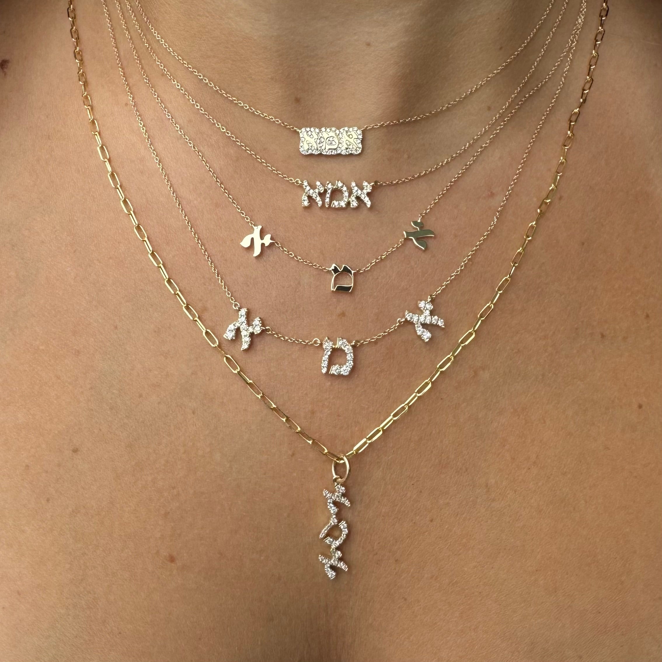 Elegant layered necklaces featuring Hebrew letters in gold and silver, showcasing a unique cultural jewelry collection.