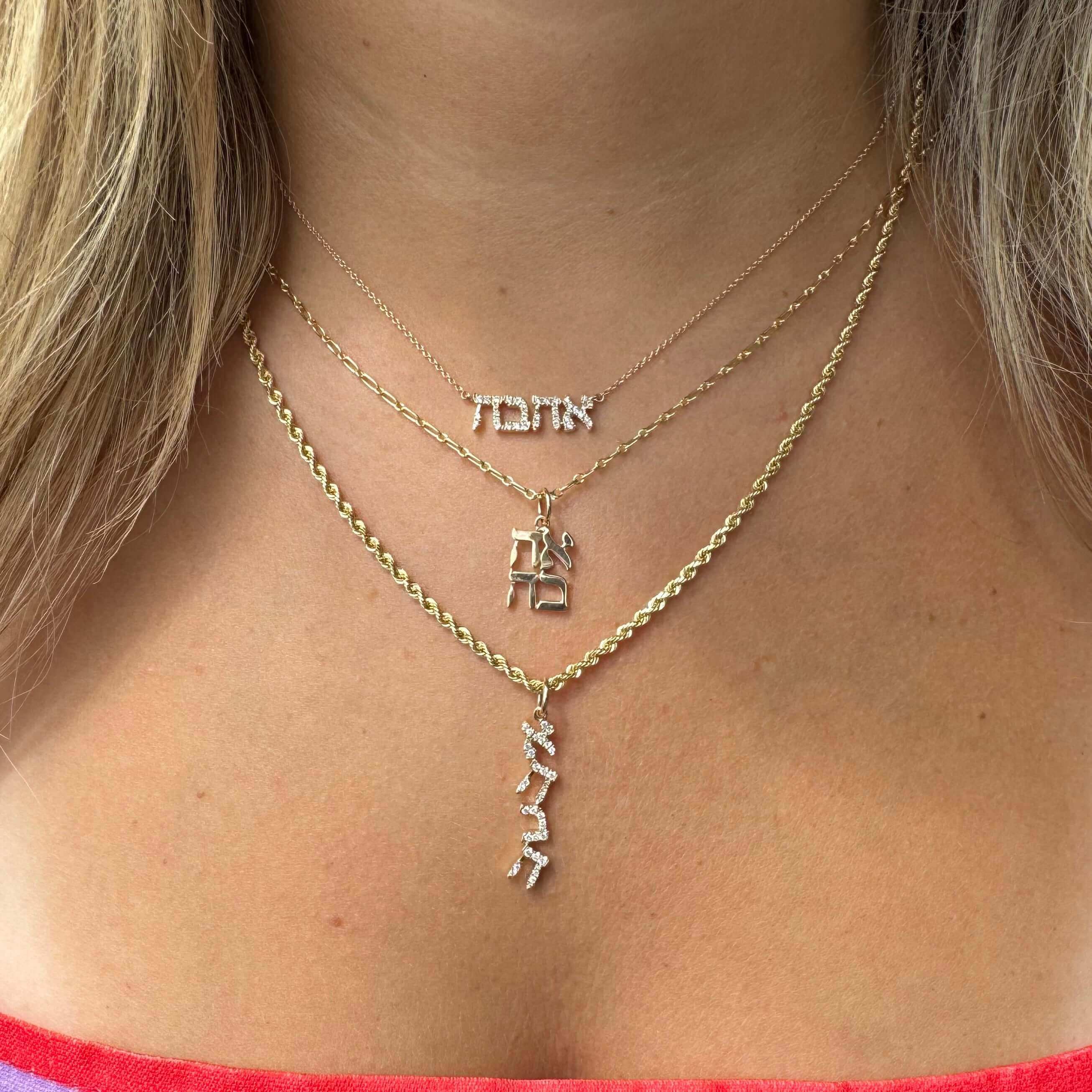 Gold Hebrew necklaces meaning love, faith, and life, displayed beautifully on a woman's neck.