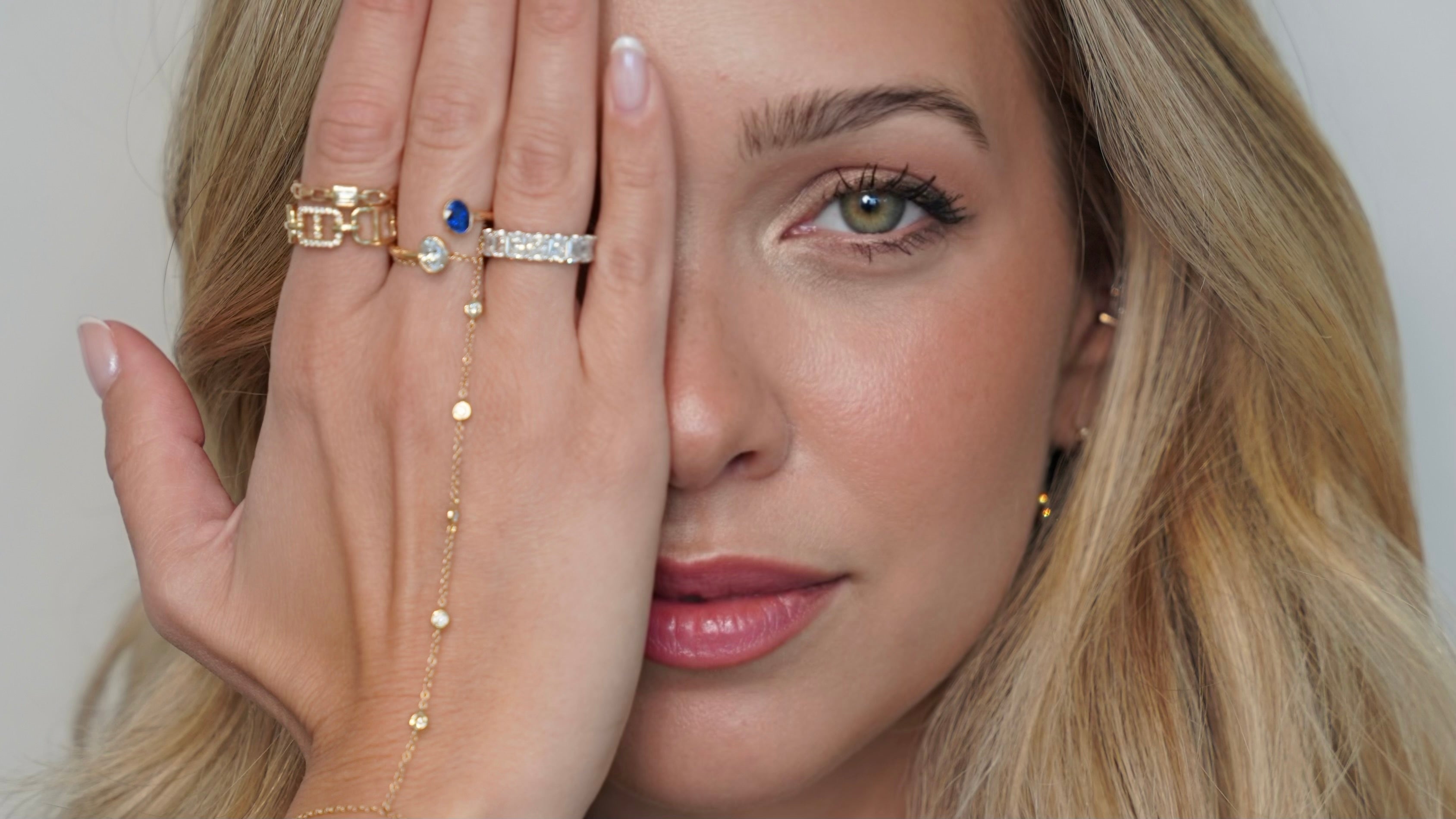 Ofir’s Favorites collection features a woman showcasing elegant jewelry, including earrings and bracelets.