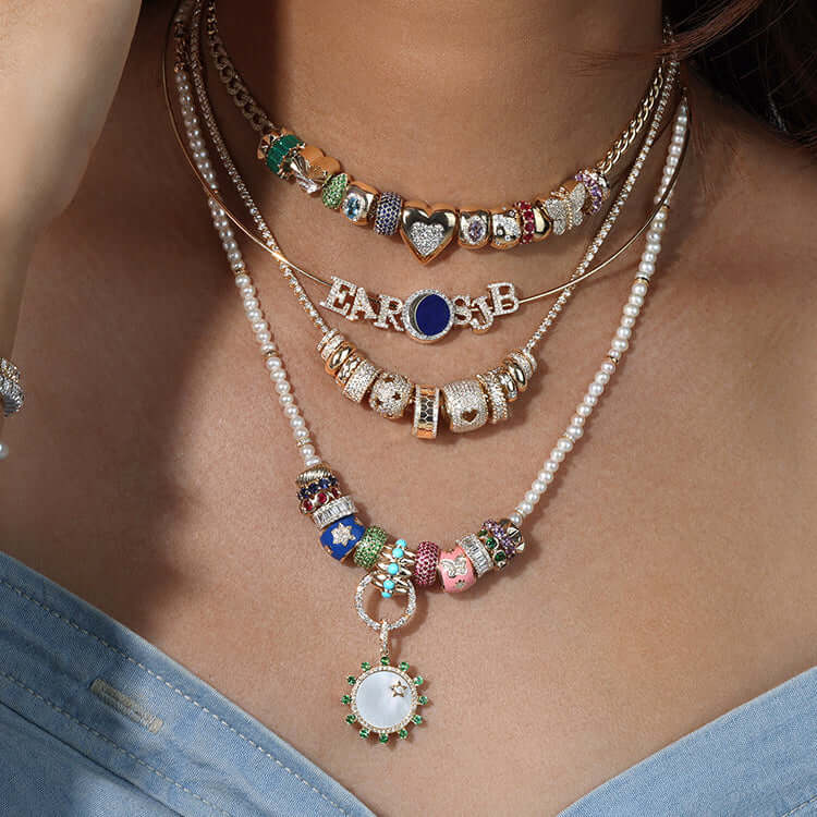 Stylish Rondelles necklaces layered on a model, featuring colorful beads and charms.