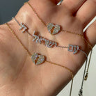 Am Yisrael Chai Hebrew Diamond Bracelet showcased on a hand, featuring diamond-encrusted letters and heart designs.