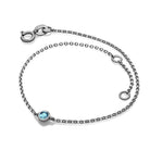 Elegant sterling silver bracelet with blue gemstone by our jewelry brand.