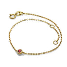 Elegant gold bracelet with a ruby gemstone by our jewelry brand.