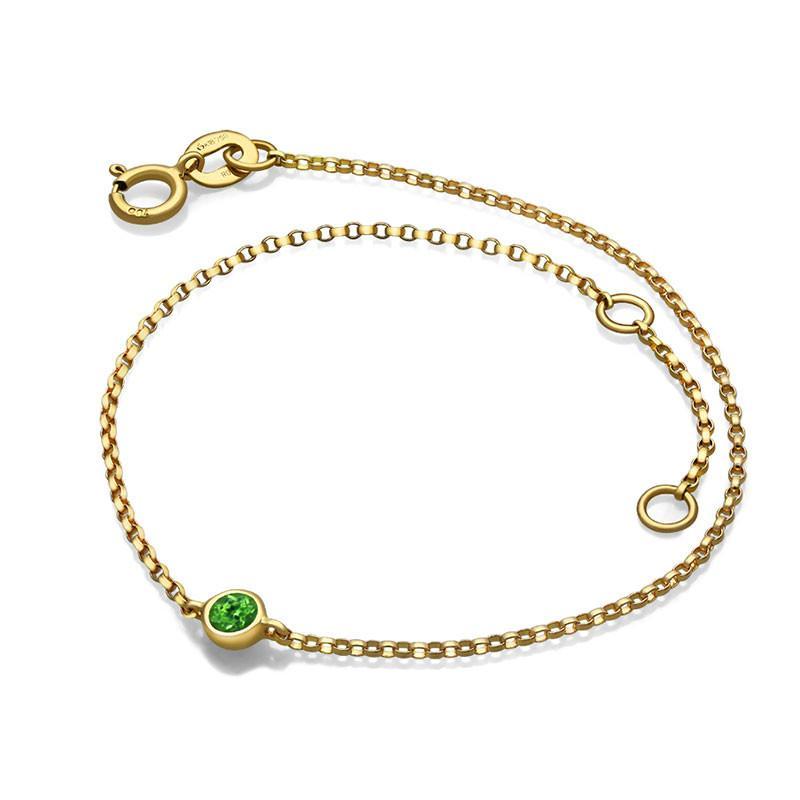 Elegant gold bracelet with green gemstone by our luxury jewelry brand.