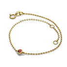 Elegant gold chain bracelet with a red gemstone, perfect for adding a touch of luxury to any outfit from our exclusive jewelry collection