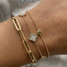 Gold chain and clover charm bracelets from our luxury jewelry collection