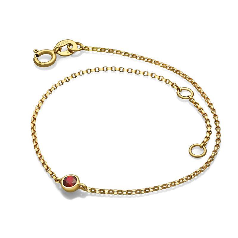 Elegant gold bracelet with a ruby gemstone by our jewelry brand.