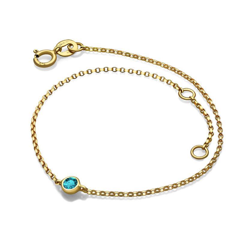 Elegant gold chain bracelet with blue gemstone for our jewelry brand