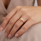 Bezel Set Pear Diamond Wrap Ring worn on a hand, showcasing the pear-shaped diamond in a 14k gold setting.