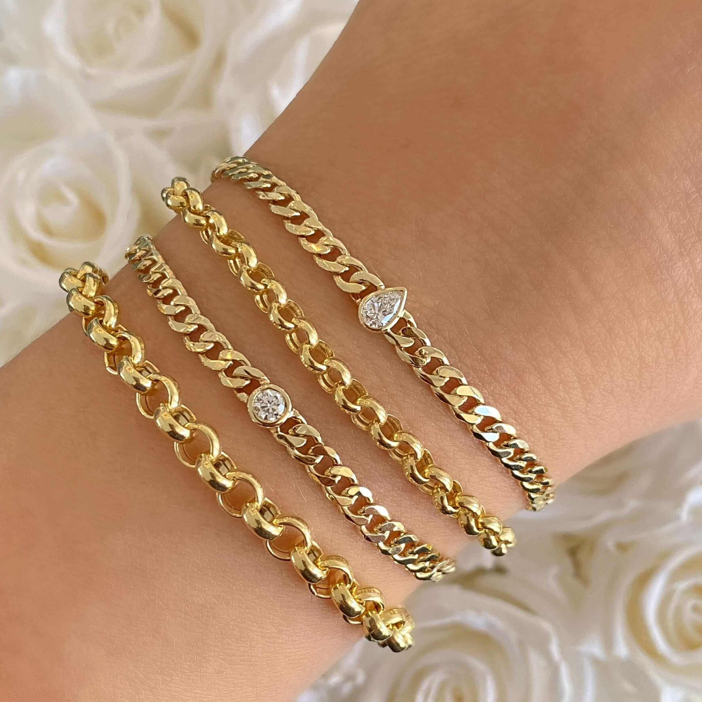 Gold chain bracelets with diamond accents on wrist from our luxurious jewelry collection