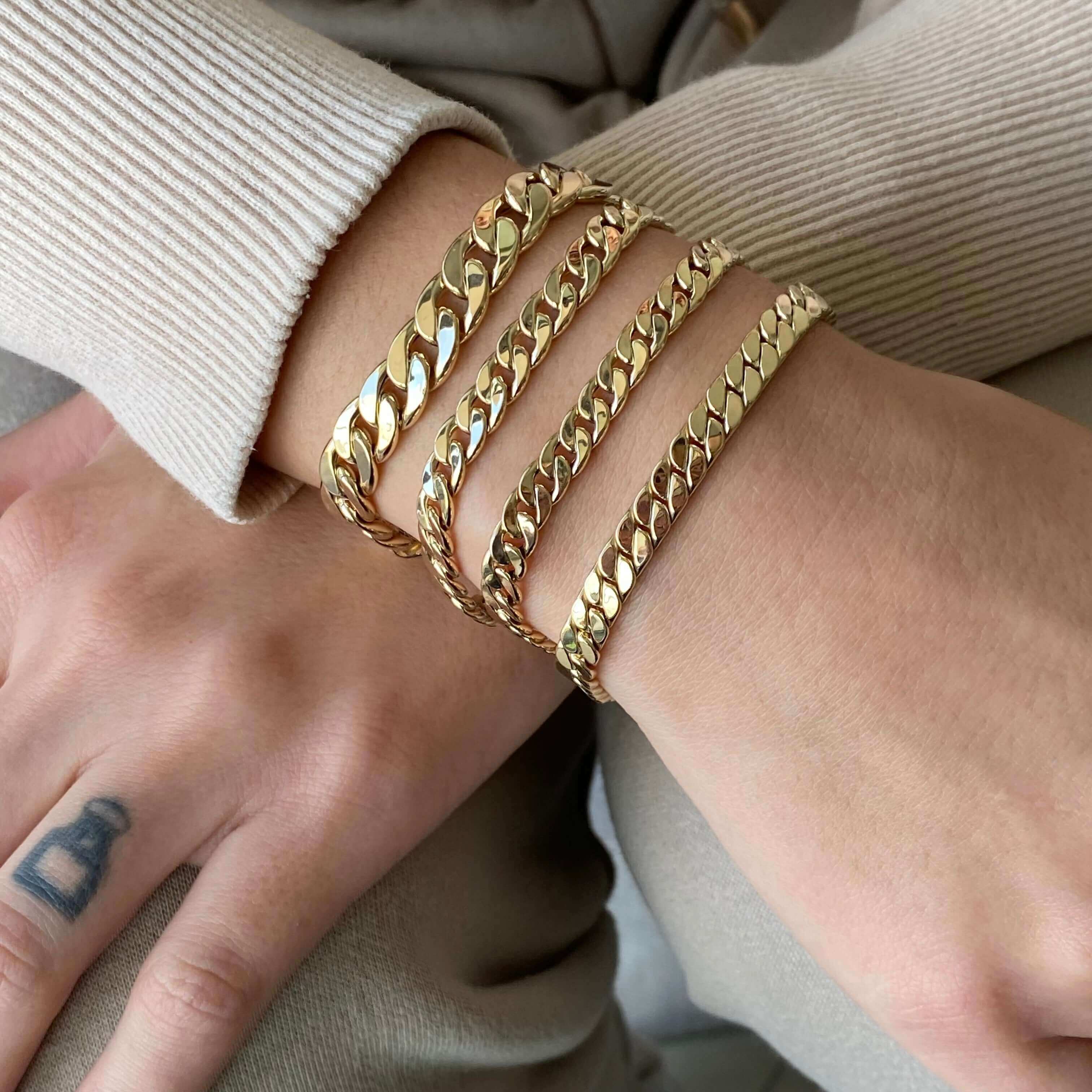 Gold chain bracelets on wrist, elegant jewelry from our collection showcasing luxurious style and craftsmanship