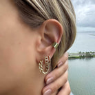 Woman wearing stylish gold chain and stud earrings from our jewelry brand, highlighting sophistication and elegance.