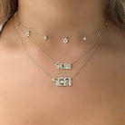 Dainty gold necklaces with Hebrew letters and star charms, beautifully layered to enhance any outfit, perfect for expressing personal style.