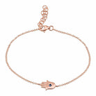 Rose gold chain bracelet with hamsa hand charm and blue gemstone by our jewelry brand