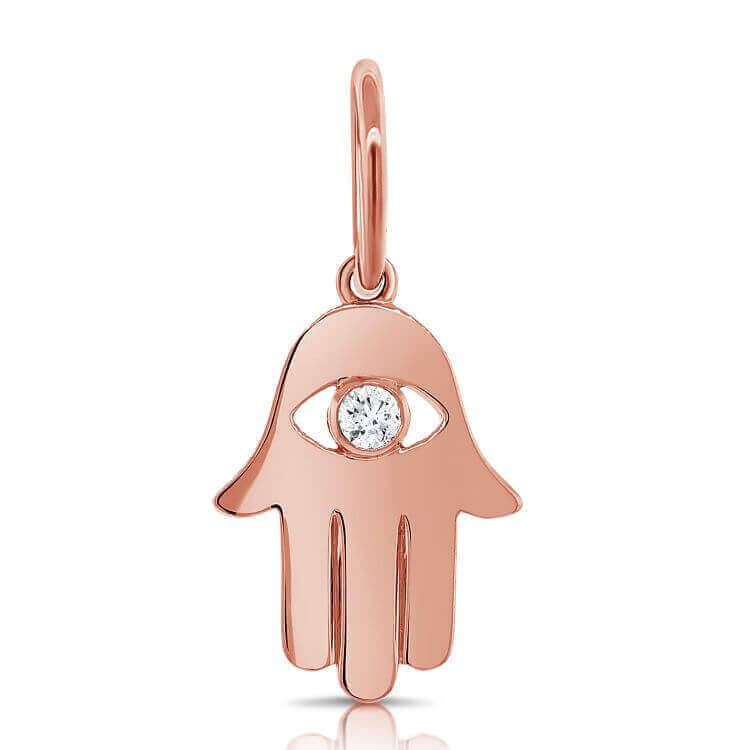 Rose gold Hamsa hand pendant with a diamond center by our jewelry brand. Perfect for adding a touch of elegance and protection to any outfit.