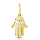 Gold Hamsa hand pendant with a central gemstone by our jewelry brand.