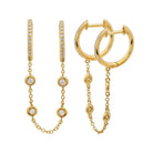 Elegant gold hoop earrings with diamond accents and dangling chains from our luxury jewelry collection.