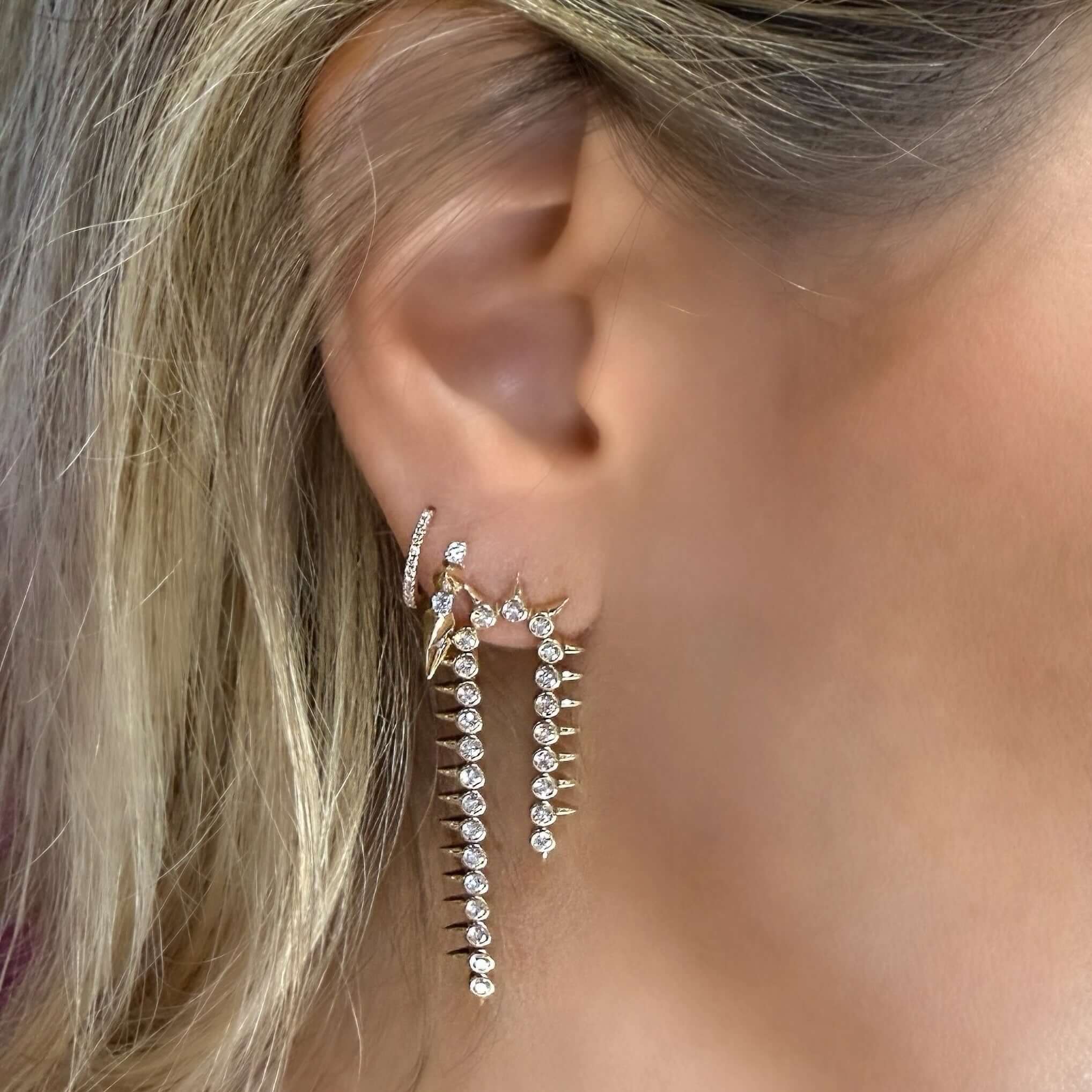 14K Gold Diamond Bezel Spikes Drop Earrings showcased in close-up on model's ear