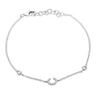 Silver horseshoe charm bracelet by our jewelry brand with delicate chain and clasp closure.