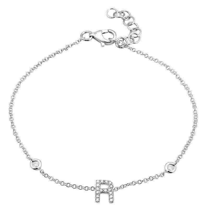 Elegant silver bracelet with an "R" initial charm, featuring delicate chain and lobster clasp from our exclusive jewelry collection.