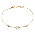 Elegant gold bracelet with diamond-studded "H" pendant from our luxury jewelry collection.