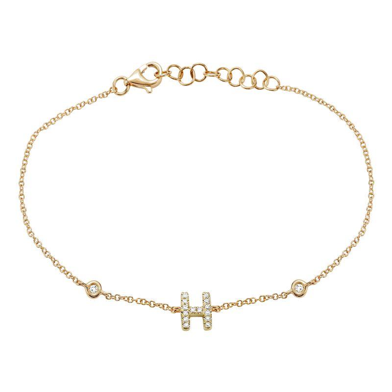 Elegant gold bracelet with diamond-studded "H" pendant from our luxury jewelry collection.