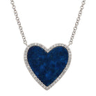 Sterling silver necklace with heart-shaped blue stone pendant and diamond accents, elegant piece from our exclusive jewelry collection.