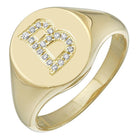 Gold signet ring with diamond-encrusted letter B showcasing elegant personalization in luxury jewelry.