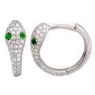 Luxe snake-inspired stud earrings with sparkling diamonds and emerald green eyes, exquisite design by our jewelry brand.