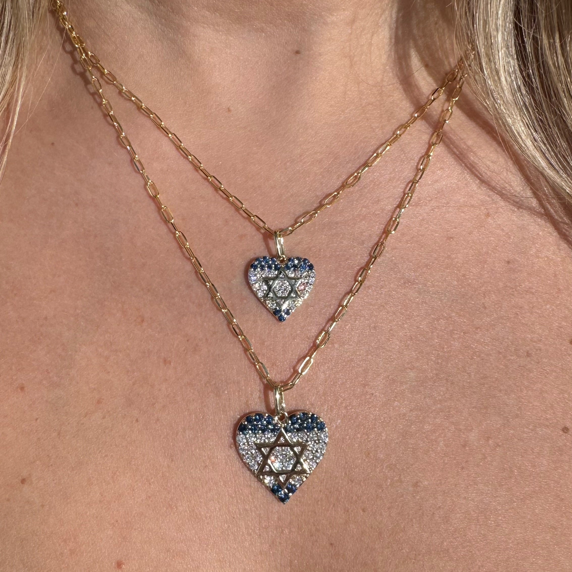 Layered 14K gold heart necklaces with diamonds and sapphires, showcasing the Israel flag design.