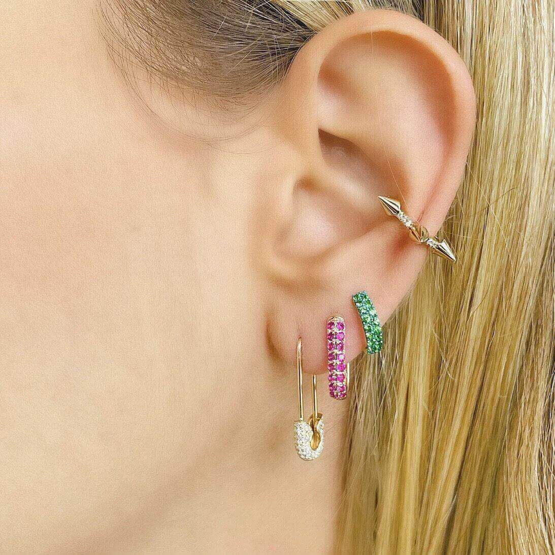 Close-up of a woman's ear showcasing colorful gemstone hoop earrings from our jewelry collection.