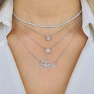 Layered silver necklaces with sparkling pendants and personalized name pendant, elegant jewelry by [Your Jewelry Brand]