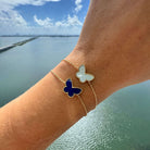 Elegant 14K Gold Gemstone Butterfly Bracelet with lapis and mother of pearl, featuring a delicate milgrain outline.