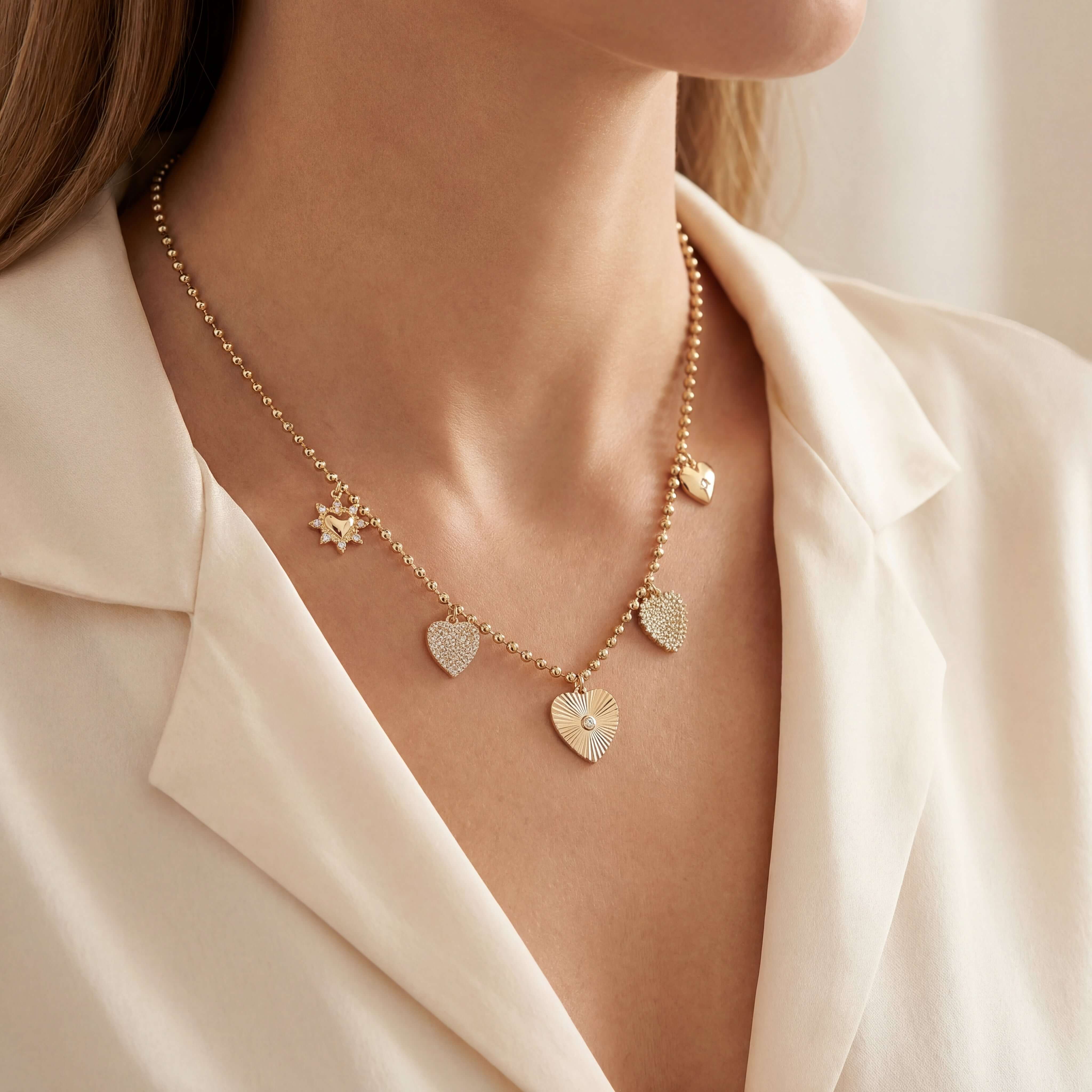 Heart Charms Beaded Ball Diamond Necklace featuring gold heart charms on a delicate chain, perfect for elegant styling.