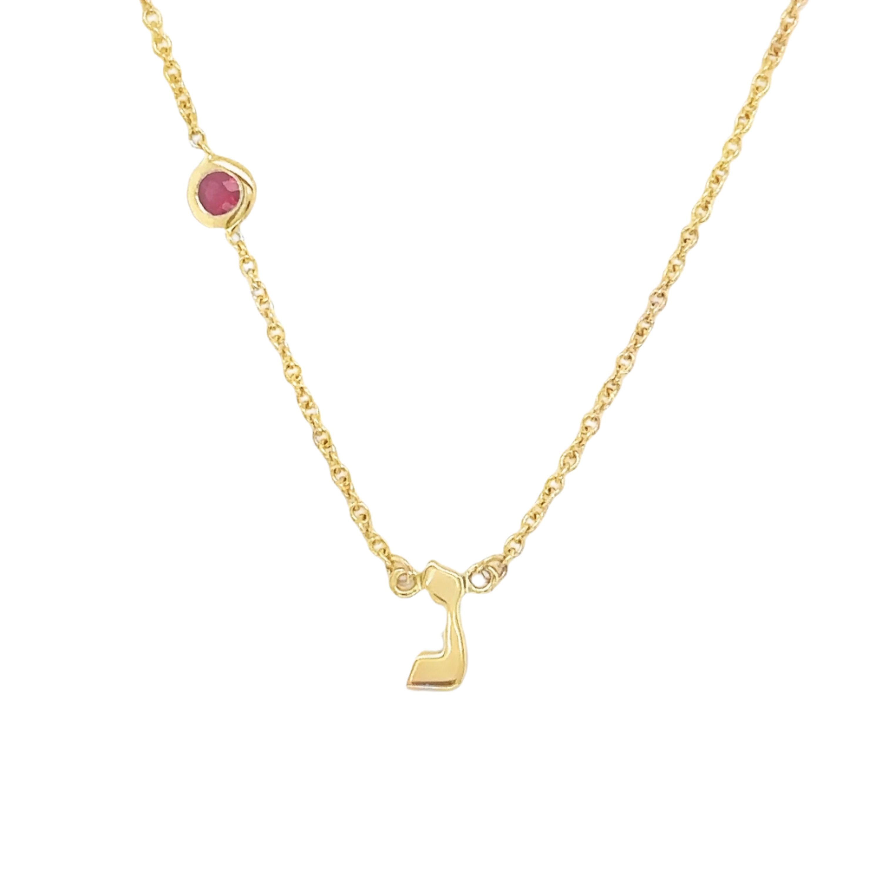 Elegant gold necklace with a red gemstone and unique charm from our jewelry brand collection