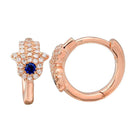 Rose gold hamsa earrings with sapphire and diamond accents by our jewelry brand.