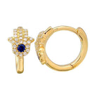 Gold hoop earrings with blue sapphire center and diamond accents from our luxury jewelry collection.