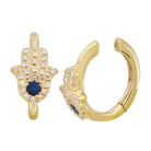 Gold Hamsa hoop earrings with sparkling gemstones and blue center stone from our luxury jewelry collection.